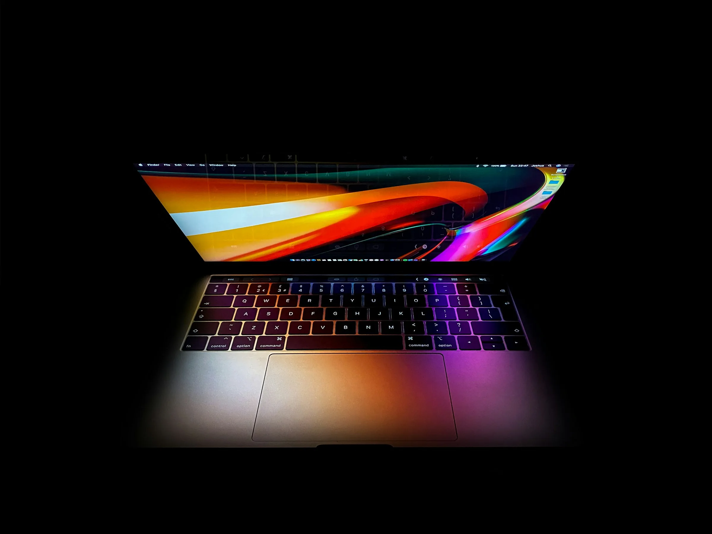 Apple MacBook open on a dark desk in the develop:IT workshop, South End, Gqeberha