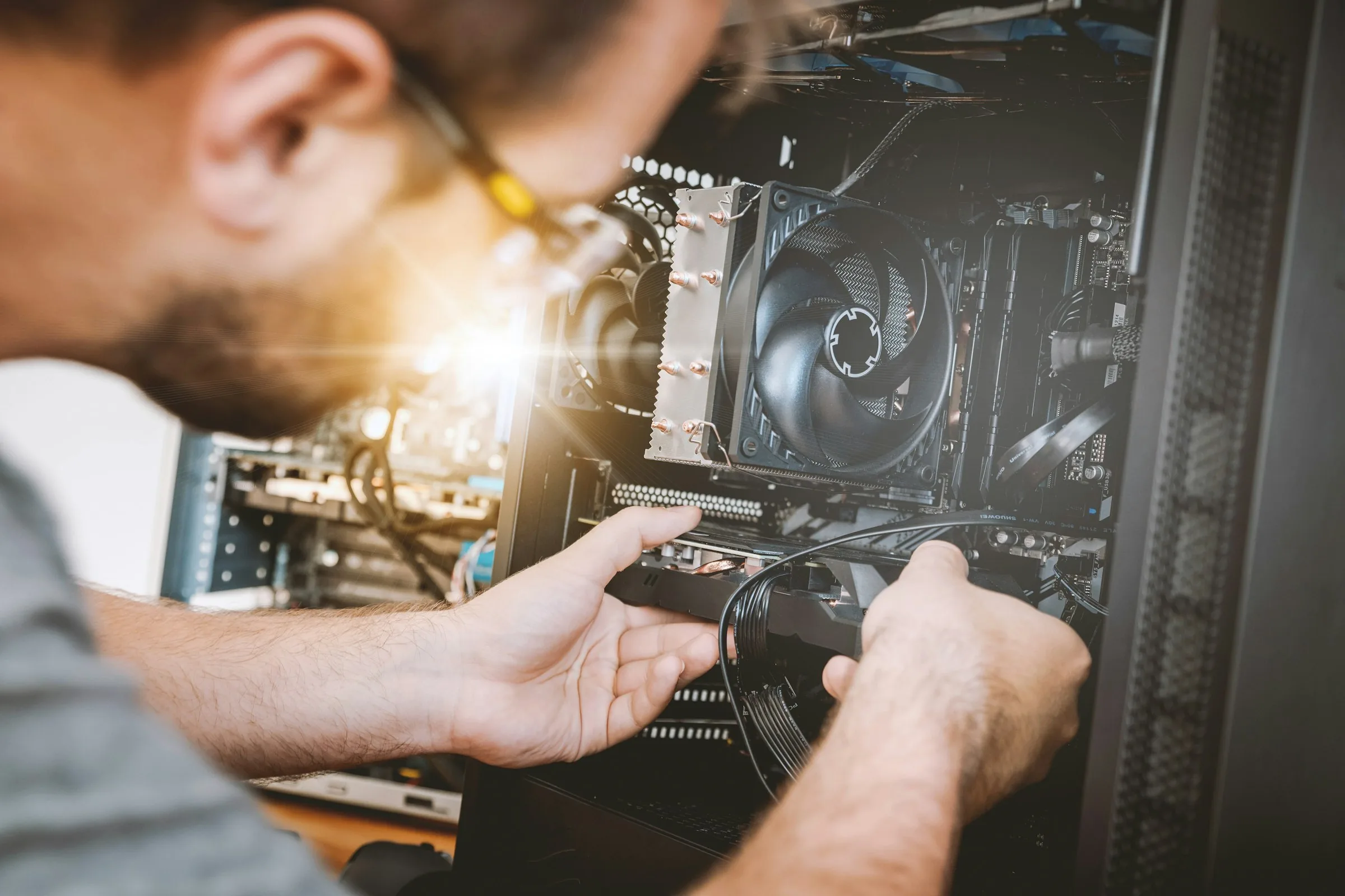 A develop:IT technician working on a PC in South End, Gqeberha